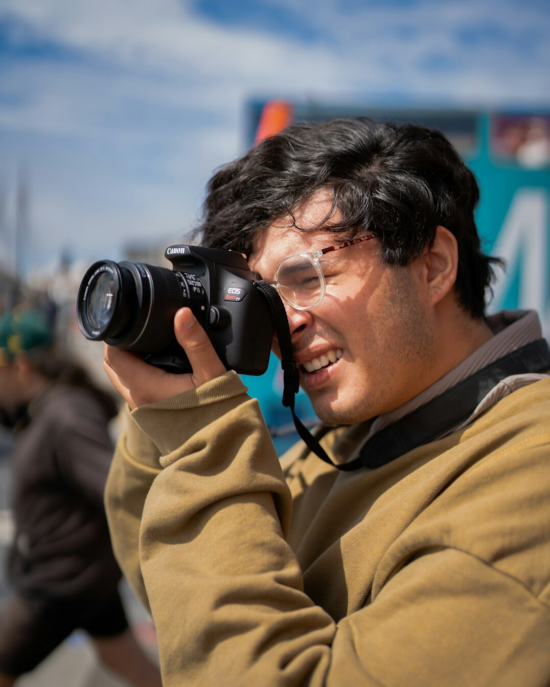 Documentary photographer holding a camera and smiling