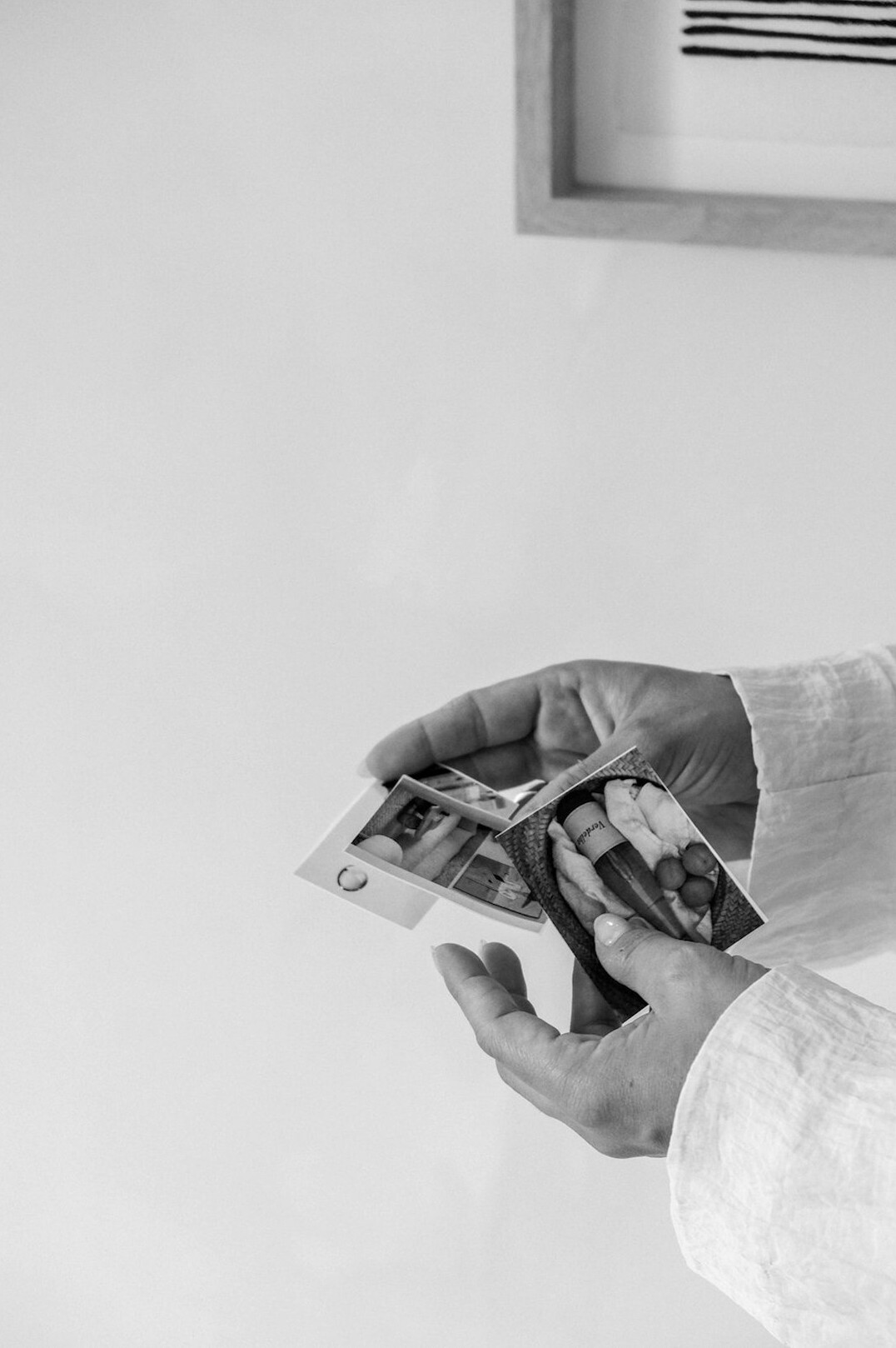 Elderly hands holding an old photograph