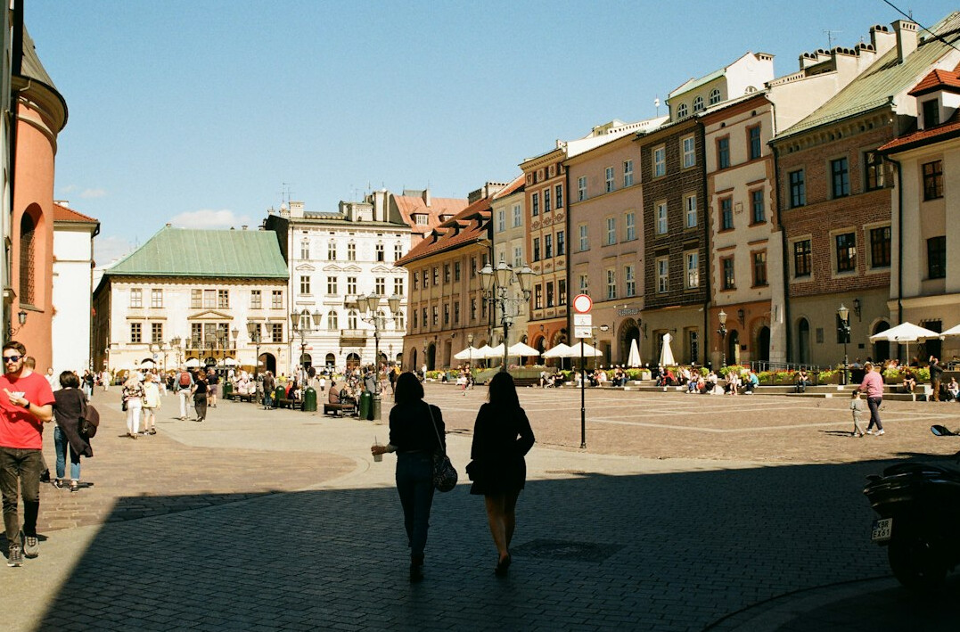 Old market square in a small Polish town with people walking